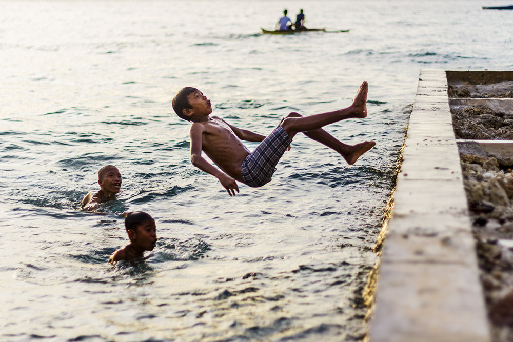 Boys frolicking at the beach in Bongao, Tawitawi